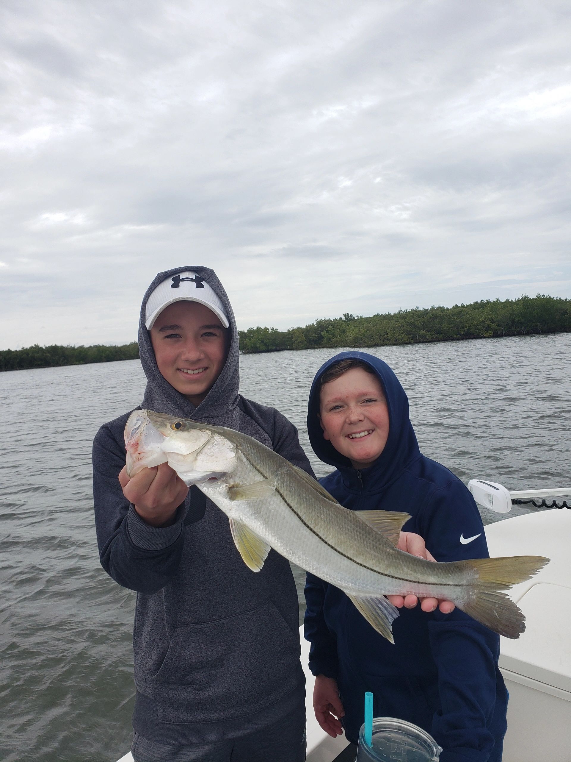 Clients with snook while on an inshore fishing charter in New Smyrna Beach