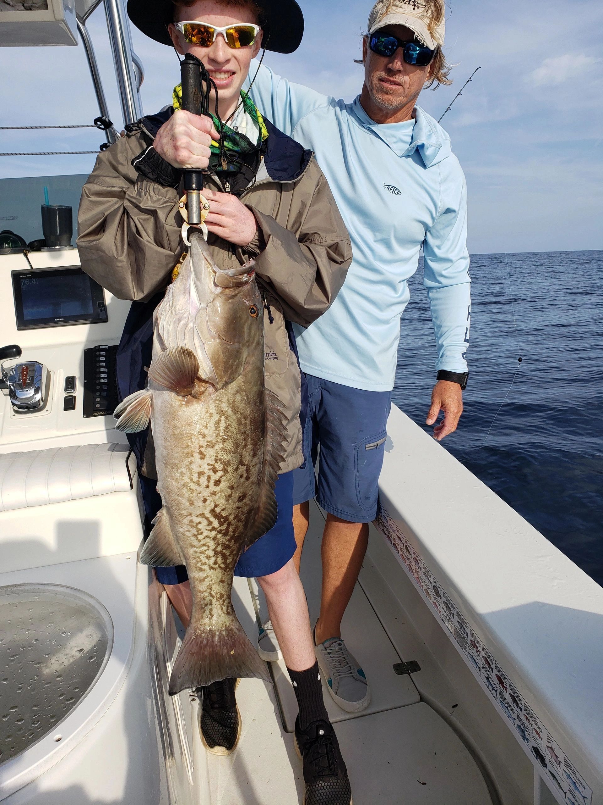 Grouper fishing with clients on a deep sea charter