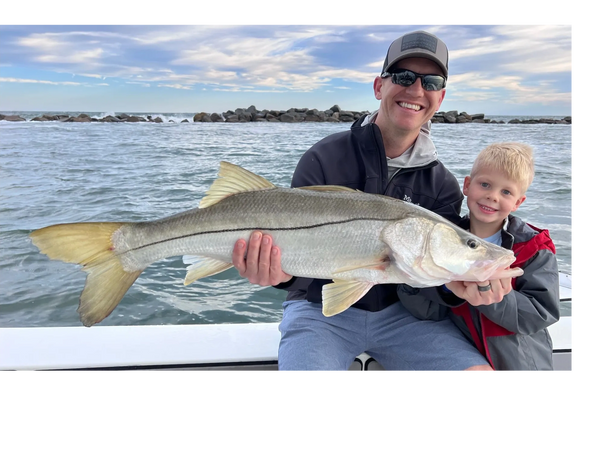 Client with snook caught while Inshore fishing charter here in New Smyrna Beach